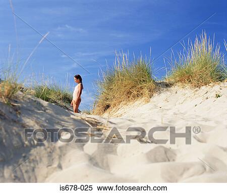 Girl standing in a sand dune View Large Photo Image Stock Photography - Girl standing in a sand dune. Fotosearch