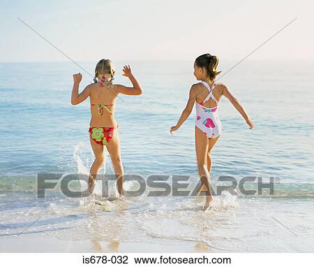 Girls splashing in the sea View Large Photo Image Stock Image - Girls splashing in the sea. Fotosearch