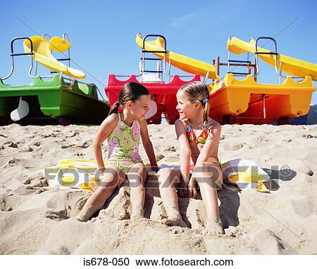 Stock Image - Two girls on the beach. Fotosearch