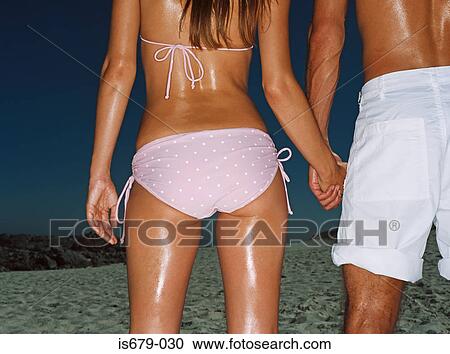 Couple holding hands on the beach View Large Photo Image Stock Image - Couple holding hands on the beach. Fotosearch