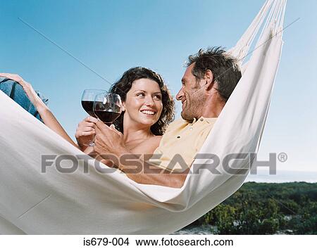 Couple in a hammock with wine View Large Photo Image Picture - Couple in a hammock with wine. Fotosearch