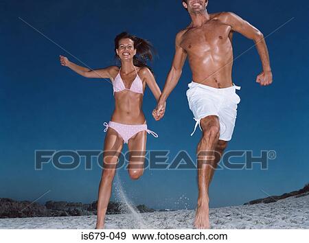 Stock Photo - Couple running on the beach. Fotosearch
