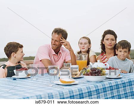 Family having breakfast al fresco View Large Photo Image Stock Image - Family having breakfast al fresco. Fotosearch