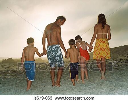 Family holding hands on the beach View Large Photo Image Stock Image - Family holding hands on the beach. Fotosearch