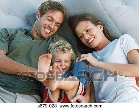 Family relaxing and laughing View Large Photo Image Stock Photo - Family relaxing and laughing. Fotosearch