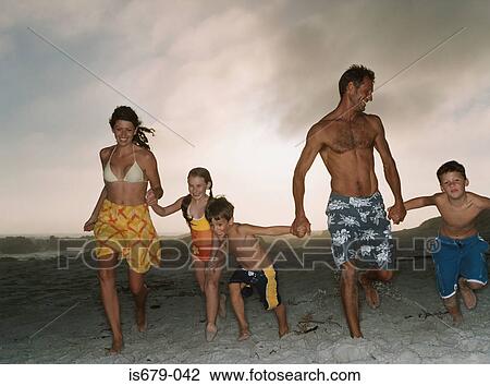 Family running on the beach View Large Photo Image Stock Image - Family running on the beach. Fotosearch