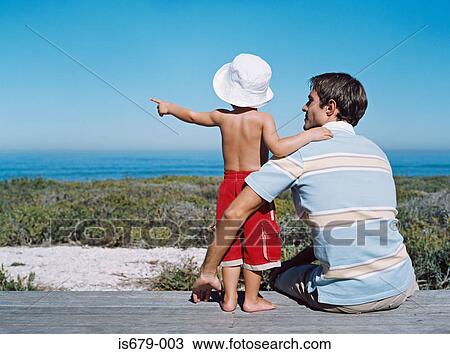 Father and son looking at the view View Large Photo Image Stock Image - Father and son looking at the view. Fotosearch