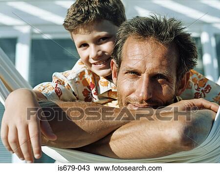 Stock Image - Father and son on hammock. Fotosearch