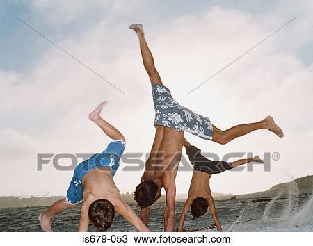 Father and sons cartwheeling View Large Photo Image Stock Image - Father and sons cartwheeling. Fotosearch