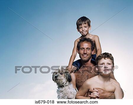 Stock Photo - Father and sons with dog. Fotosearch