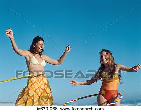 Mother and daughter with hula hoops View Large Photo Image Stock Photograph - Mother and daughter with hula hoops. Fotosearch