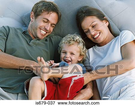 Mother and father tickling son View Large Photo Image Stock Photo - Mother and father tickling son. Fotosearch