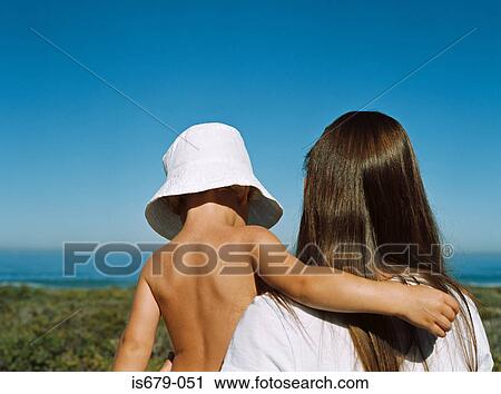 Mother and son looking out to sea View Large Photo Image Stock Image - Mother and son looking out to sea. Fotosearch