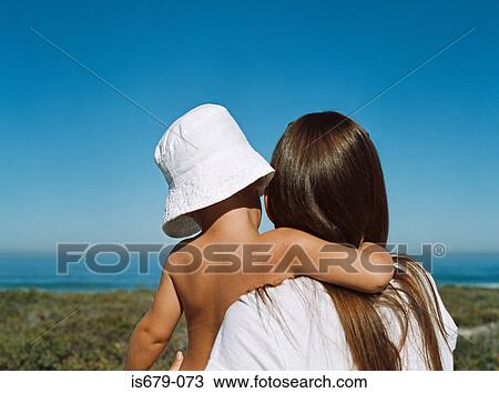 Mother and son looking out to sea View Large Photo Image Stock Image - Mother and son looking out to sea. Fotosearch