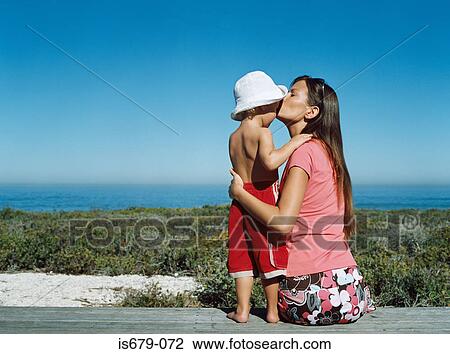 Mother kissing her son on the forehead View Large Photo Image Stock Image - Mother kissing her son on the forehead. Fotosearch