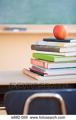 Apple on a stack of books View Large Photo Image Stock Photo - Apple on a stack of books. Fotosearch