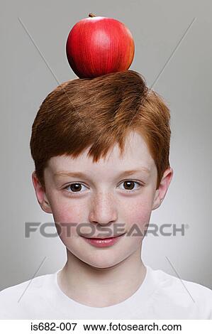 Stock Photo - Boy balancing an apple on his head. Fotosearch