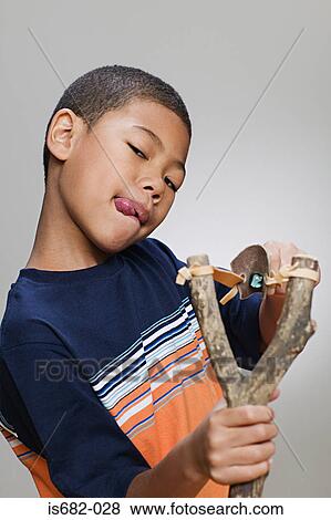 Boy using a catapult View Large Photo Image Stock Photo - Boy using a catapult. Fotosearch