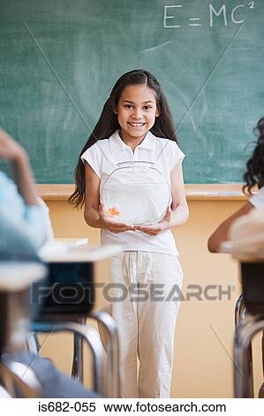 Stock Photography - Girl giving a presentation in classroom. Fotosearch