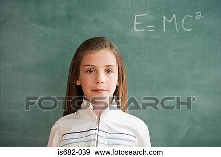Girl standing at blackboard View Large Photo Image Stock Photo - Girl standing at blackboard. Fotosearch