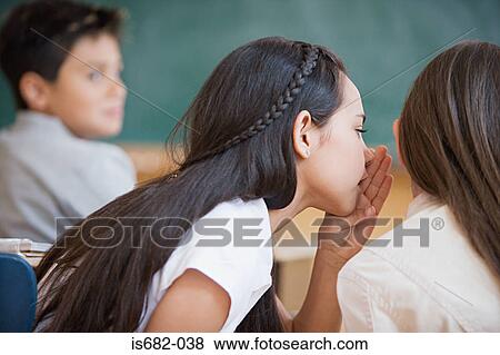 Girls whispering in class View Large Photo Image Stock Photo - Girls whispering in class. Fotosearch