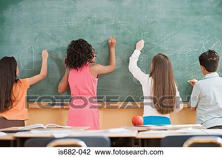 Schoolchildren writing on a blackboard View Large Photo Image Stock Image - Schoolchildren writing on a blackboard. Fotosearch