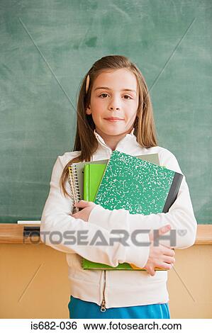 Schoolgirl holding textbooks View Large Photo Image Stock Photograph - Schoolgirl holding textbooks. Fotosearch