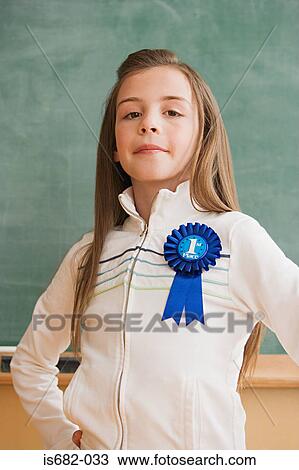 Schoolgirl wearing a rosette View Large Photo Image Stock Image - Schoolgirl wearing a rosette. Fotosearch