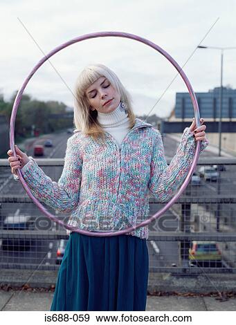 Woman holding hula hoop on motorway bridge View Large Photo Image Stock Photo - Woman holding hula hoop on motorway bridge. Fotosearch