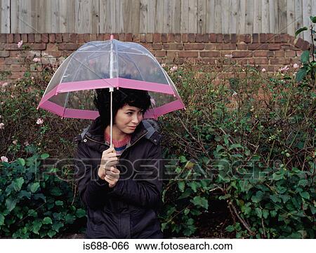 Woman holding transparent umbrella View Large Photo Image Stock Photograph - Woman holding transparent umbrella. Fotosearch