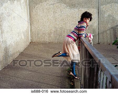Woman leaning on a railing View Large Photo Image Stock Photograph - Woman leaning on a railing. Fotosearch