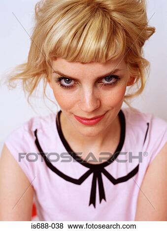 Woman looking mischievous View Large Photo Image Stock Photo - Woman looking mischievous. Fotosearch