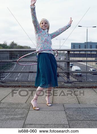 Woman playing with hula hoop on motorway bridge View Large Photo Image Stock Image - Woman playing with hula hoop on motorway bridge. Fotosearch
