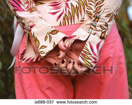 Woman with hands behind back View Large Photo Image Stock Photo - Woman with hands behind back. Fotosearch