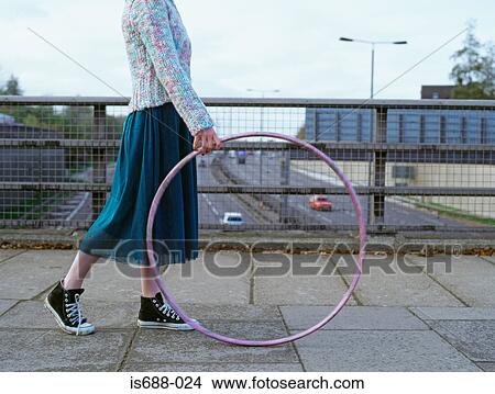Woman with hula hoop on motorway bridge View Large Photo Image Picture - Woman with hula hoop on motorway bridge . Fotosearch