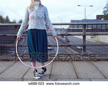 Woman with hula hoop on motorway bridge View Large Photo Image Stock Image - Woman with hula hoop on motorway bridge. Fotosearch