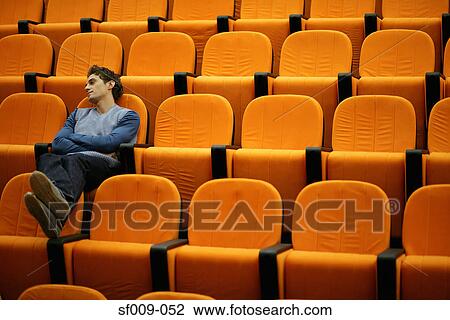 Drowsy young man alone in lecture theatre View Large Photo Image Stock Image - Drowsy young man alone in lecture theatre. Fotosearch
