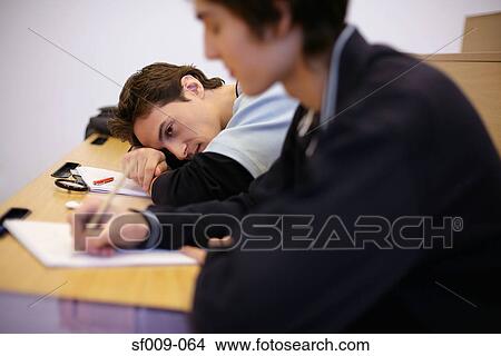 Student resting his head on desk View Large Photo Image Picture - Student resting his head on desk. Fotosearch