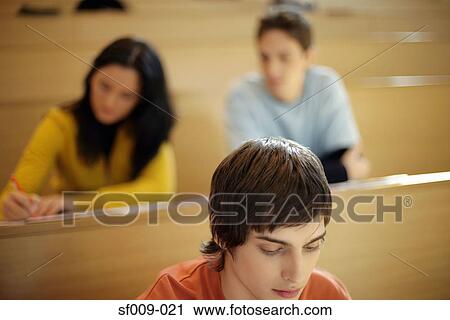 Stock Image - Three students in a lecture. Fotosearch
