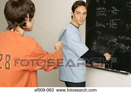 Two students in a classroom View Large Photo Image Stock Image - Two students in a classroom. Fotosearch