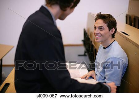 Stock Photo - Two young men in a lecture theatre. Fotosearch