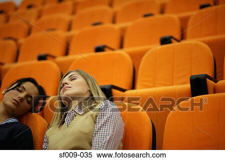 Two young women asleep in a lecture theatre View Large Photo Image Stock Photography - Two young women asleep in a lecture theatre. Fotosearch