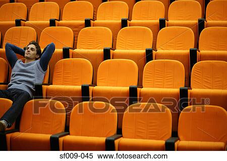 Young man alone in lecture theatre View Large Photo Image Stock Photography - Young man alone in lecture theatre. Fotosearch