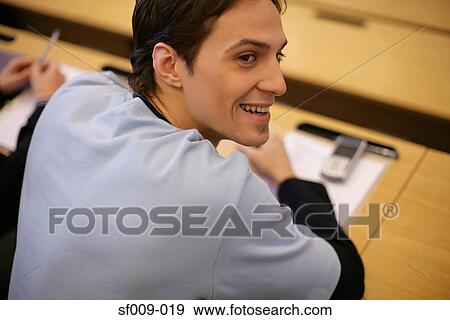 Stock Photo - Young man in a lecture. Fotosearch