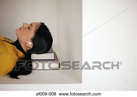 Young woman asleep on her books View Large Photo Image Stock Photo - Young woman asleep on her books. Fotosearch