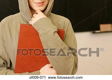 Stock Image - Young woman in a hooded sweater. Fotosearch