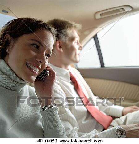 Stock Photo - Business people in a taxi. Fotosearch