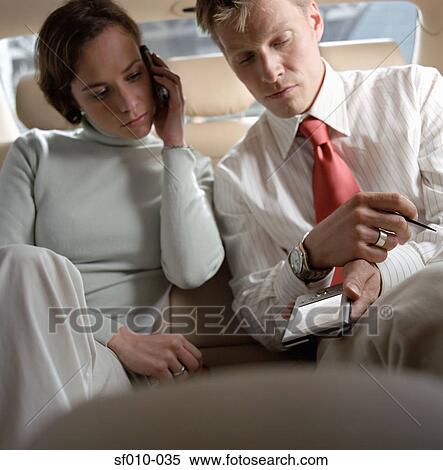 Business people in a taxi View Large Photo Image Stock Photography - Business people in a taxi. Fotosearch