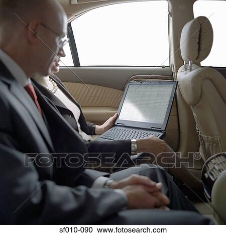 Business people in taxi with laptop View Large Photo Image Stock Image - Business people in taxi with laptop. Fotosearch