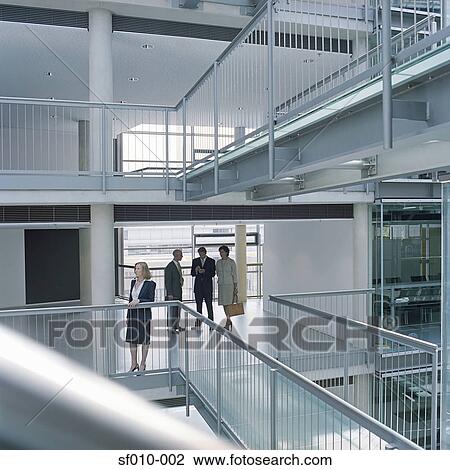 Stock Image - Business people looking at an office. Fotosearch